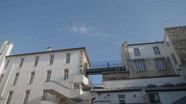 The school building related to "Château rouge", with a bridge connecting structures.