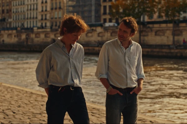 Two men converse by a river in Love Me Tender.